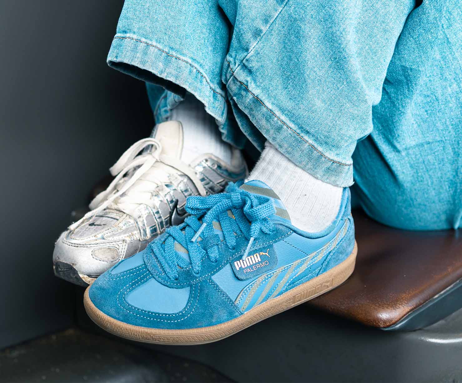 Person wearing mismatched sneakers for Mismatched Shoes Day